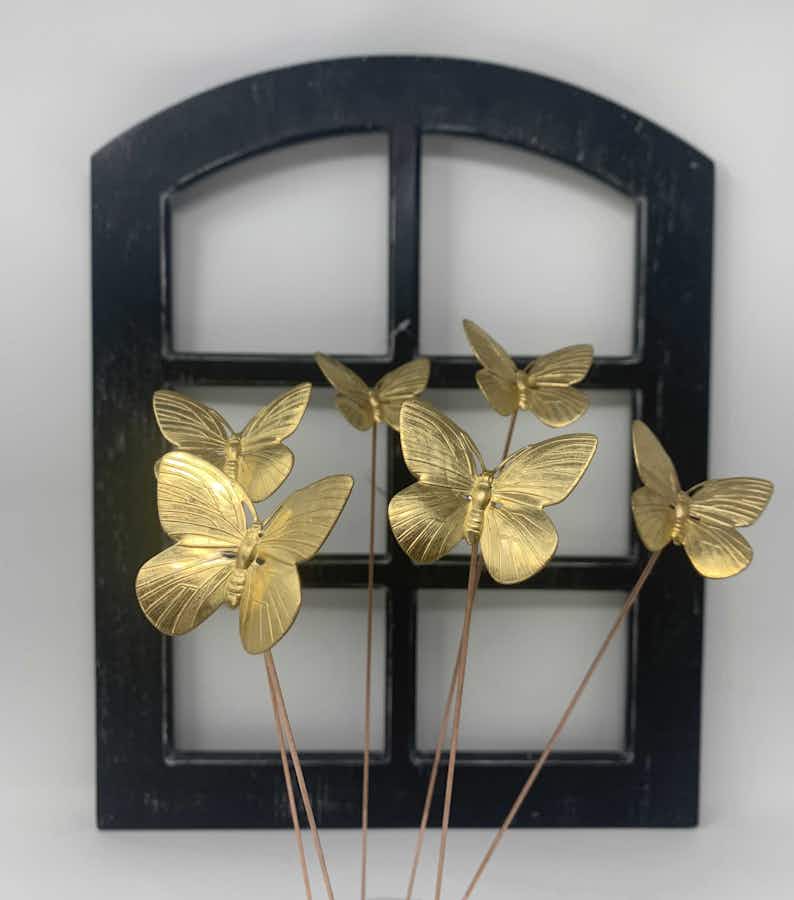Butterfly Plant Sticks (set of 6) in front of a window pane