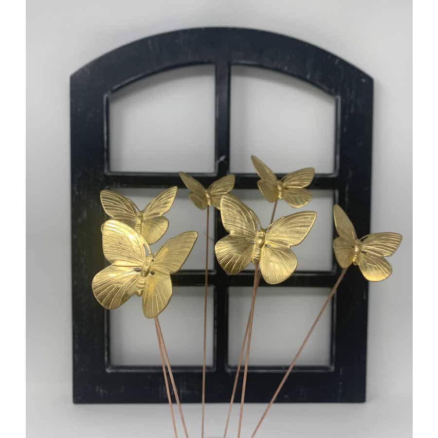 Butterfly Plant Sticks (set of 6) in front of a window pane