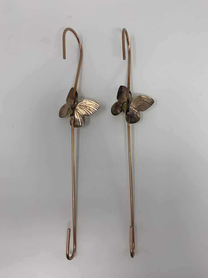 The back side of copper coated extension hook with a brass butterfly set of 2