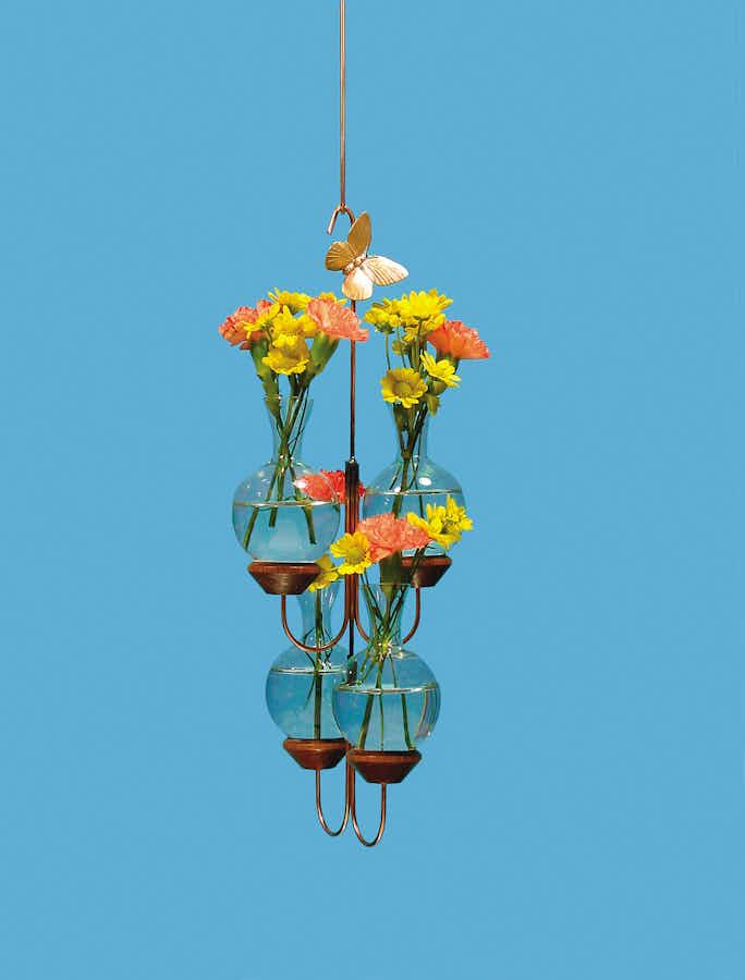 Four Vase Plant Propagation Rooter with flowers and a blue background