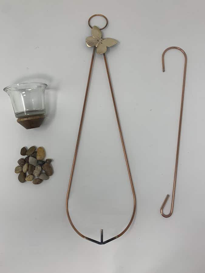 Showing what is included, an air plant holder, river stones, hook and votive