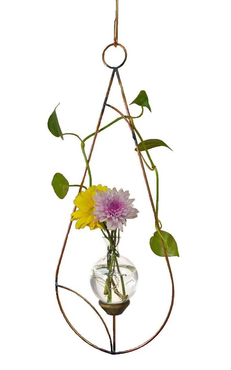 Minimalist teardrop hanging glass rooting vase with copper frame and matching hook displaying flowers and a vine